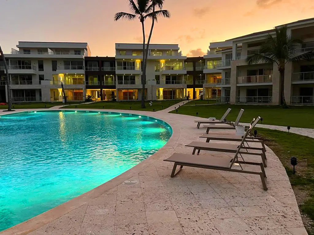 A view of the Ocean View Apartments complex, pools and loungers at sunset. 